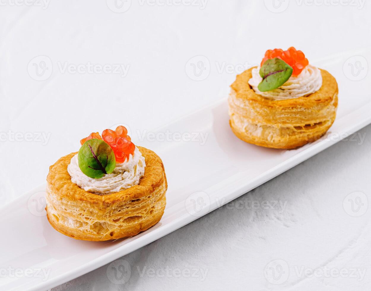 Gourmet vol-au-vent appetizers with salmon caviar photo