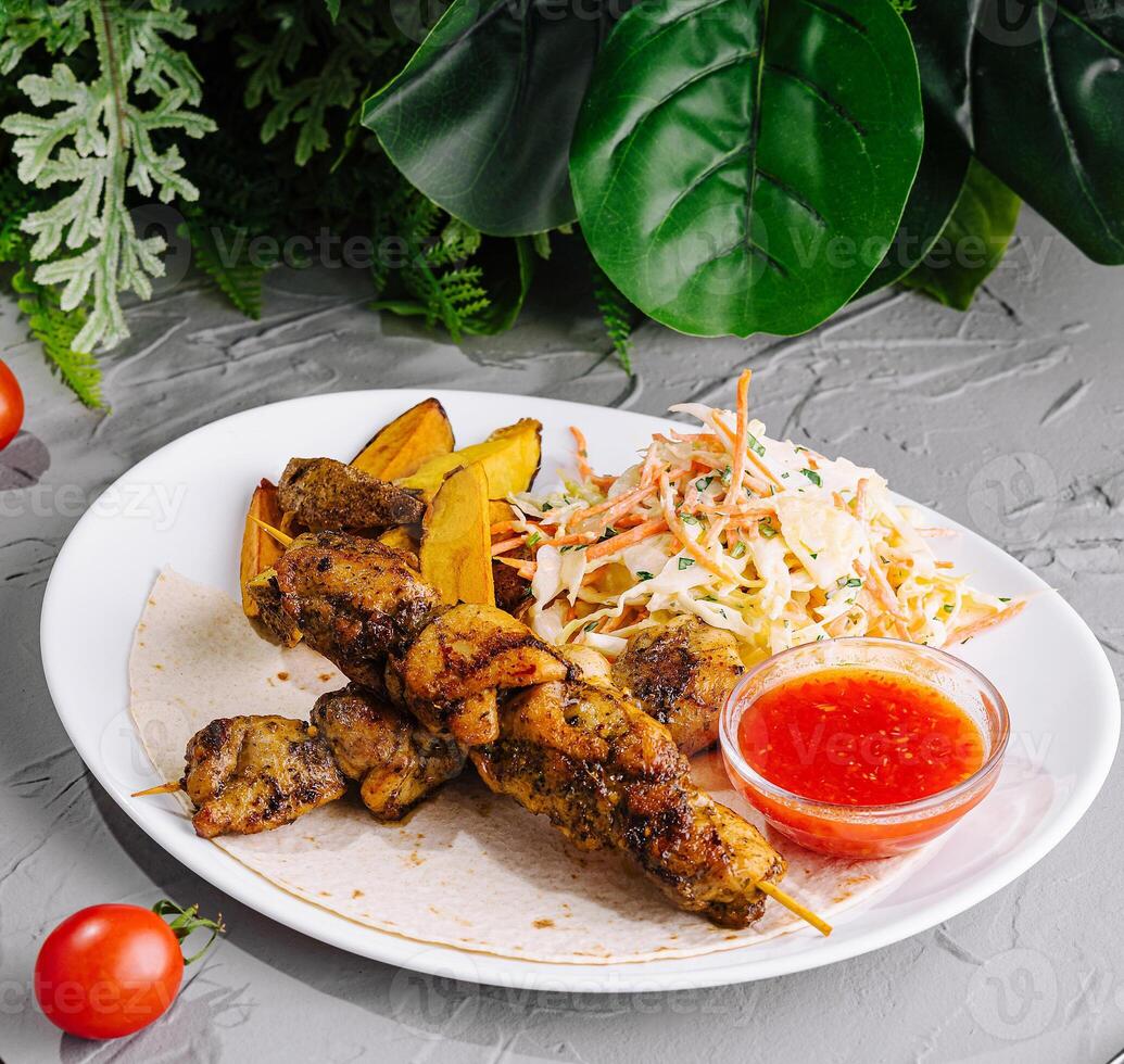 Healthy gourmet meal with grilled chicken on plate photo