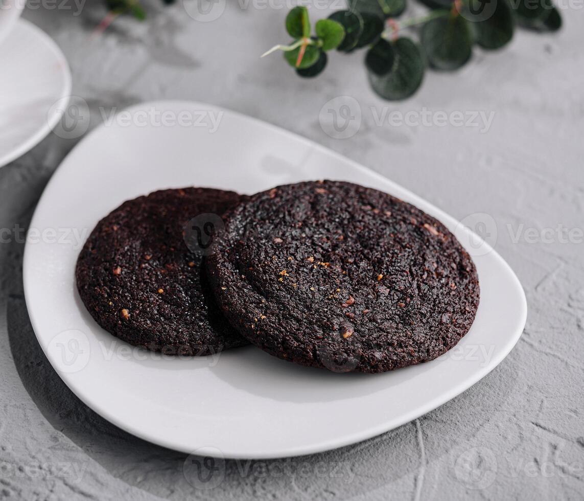 Fresh chocolate cookies on grey stone photo
