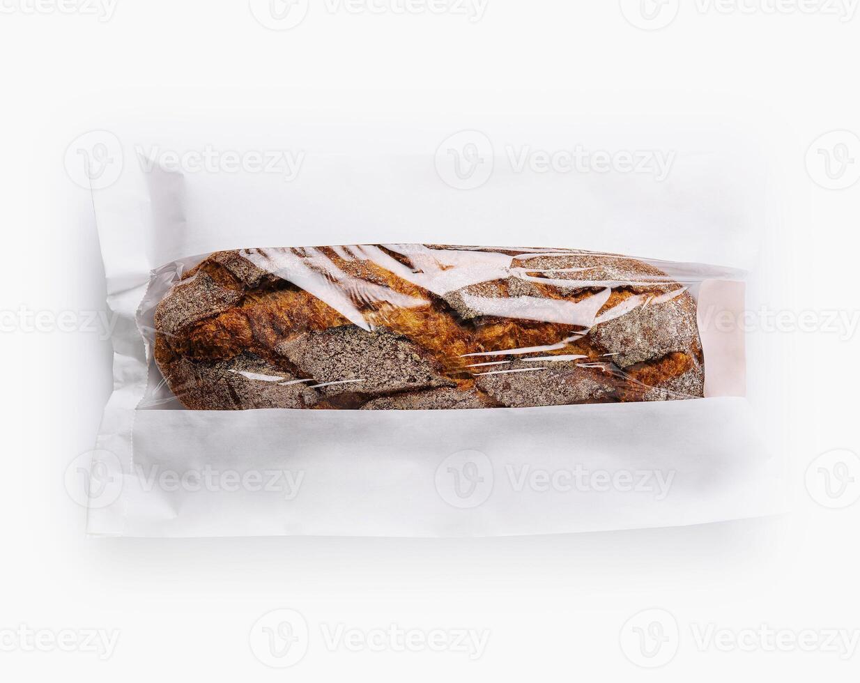 Fresh baguette in paper bag isolated on white photo