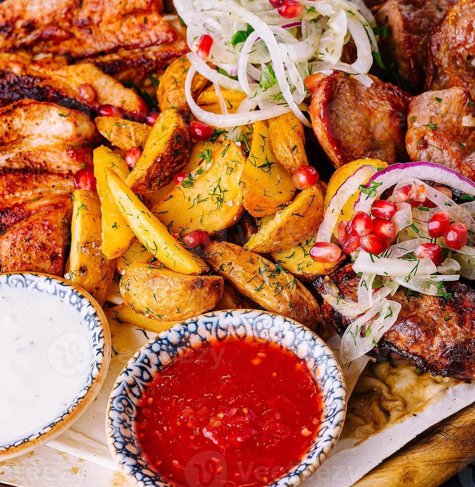 Traditional georgian feast with assorted grilled meats photo