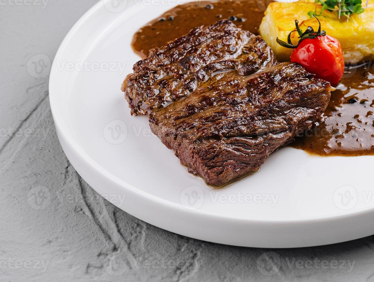 Gourmet grilled steak with potato and sauce photo