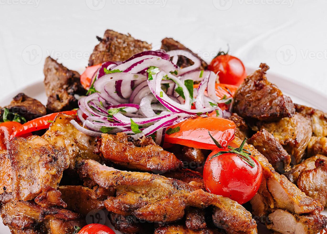 Grilled meat platter with fresh vegetables photo