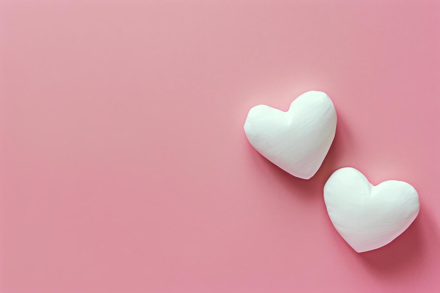 Two Heart Shaped Marshmallows on Pink Background photo