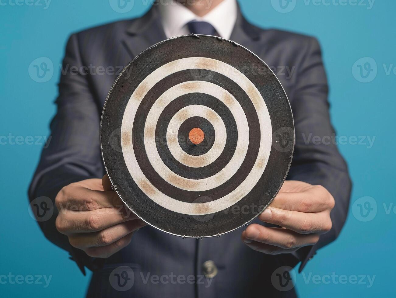 Businessman holding a dart target, dartboard, business goal concept. photo