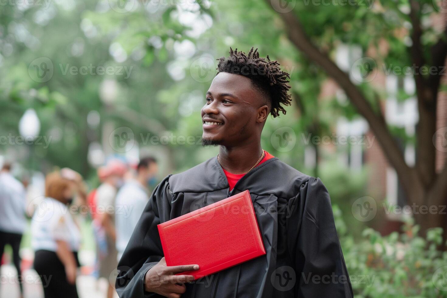 A man wearing graduation gown and holding diploma for ceremony celebration. photo