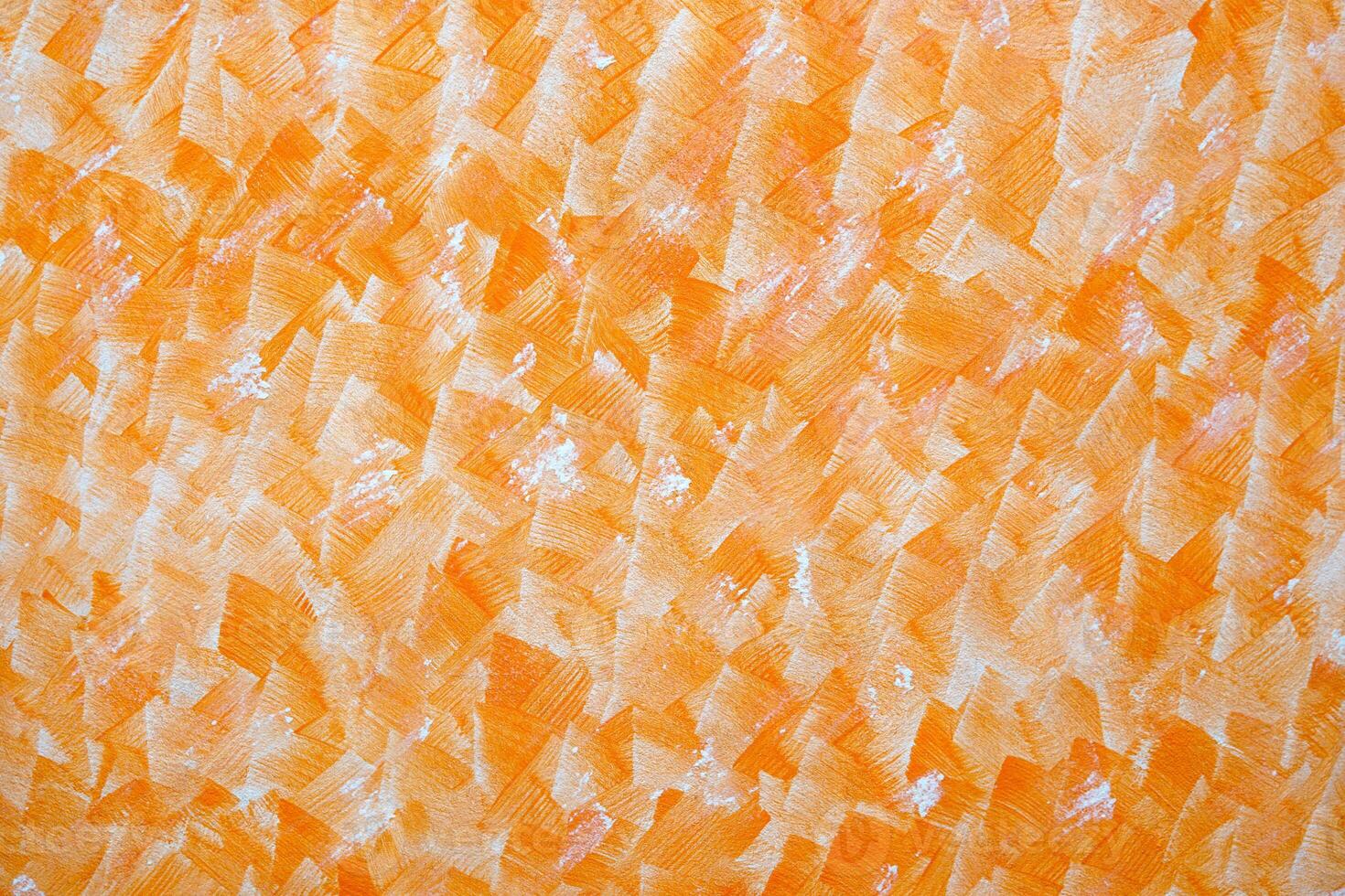 The orange concrete wall pattern is a creation of art on the wall using the technique of stamping the wall with molds to create various patterns. photo