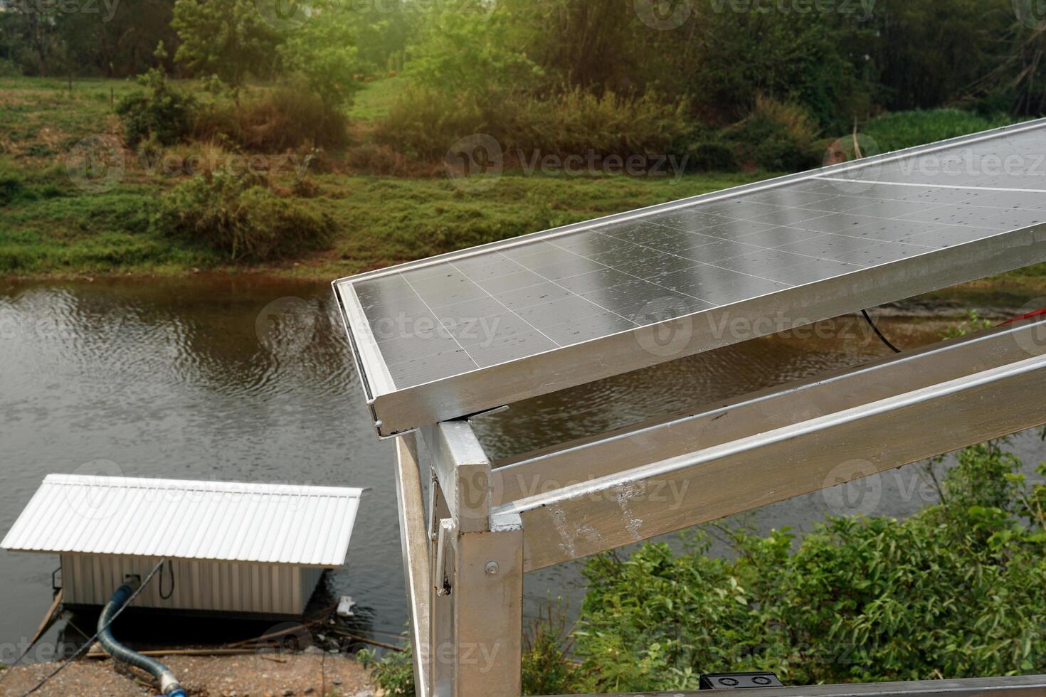 Solar power generation station, they installed several solar panels on a concrete barrier along the river to generate electricity to pump water for agricultural use. photo