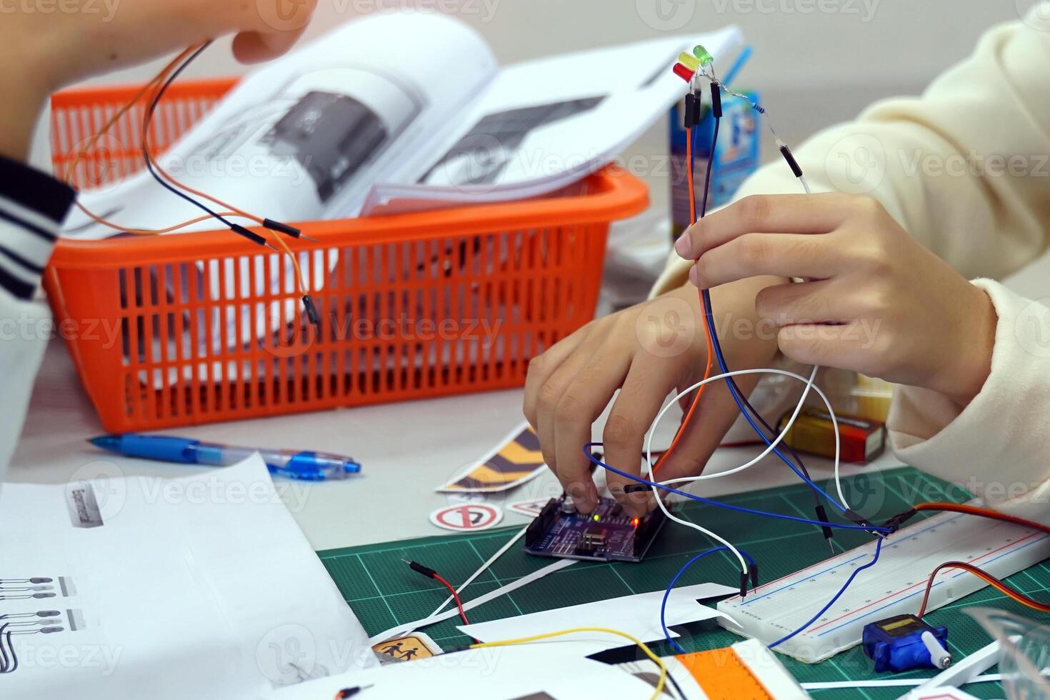 Students experiment with simple electronic circuits. Principles of traffic light circuits. Soft and selective focus. photo