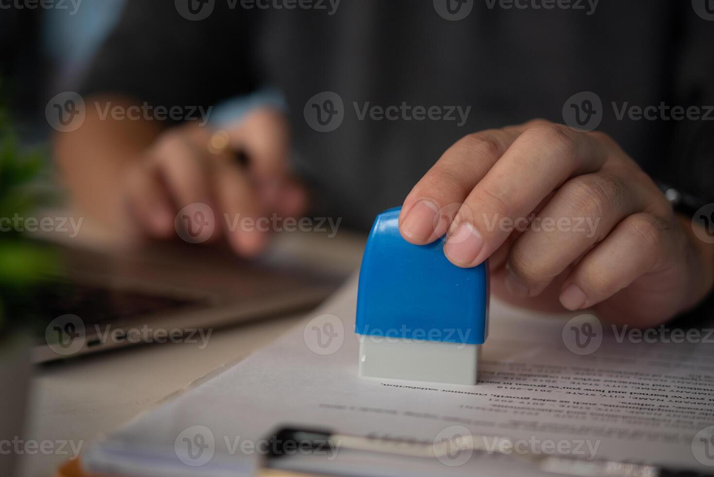 Contract law or paper work business and finance document rubber stamp. For official and legal contracts and agreements, financial statements, investment contracts, real estate documents. photo