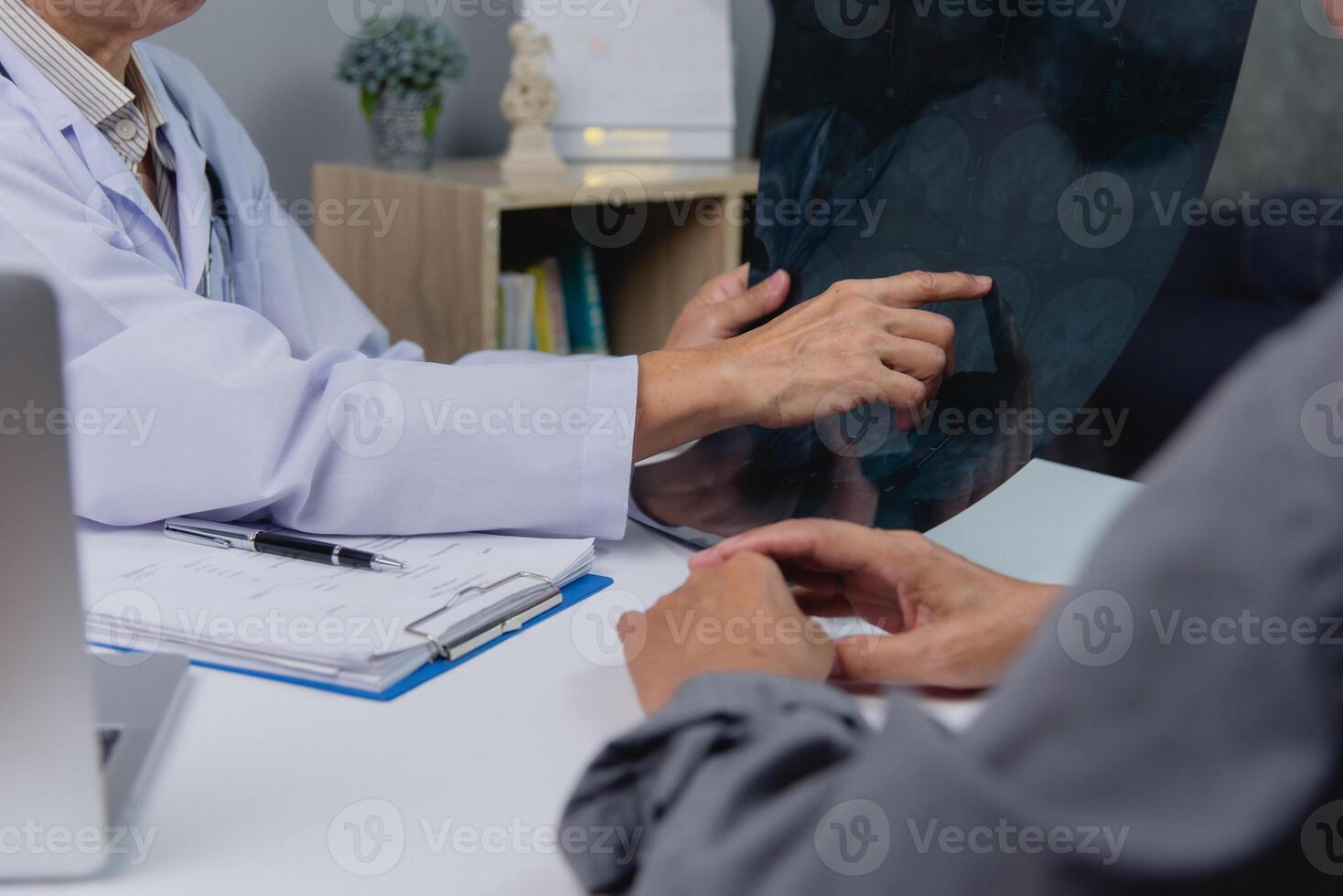 Physician consulting with patient about x-ray results. photo