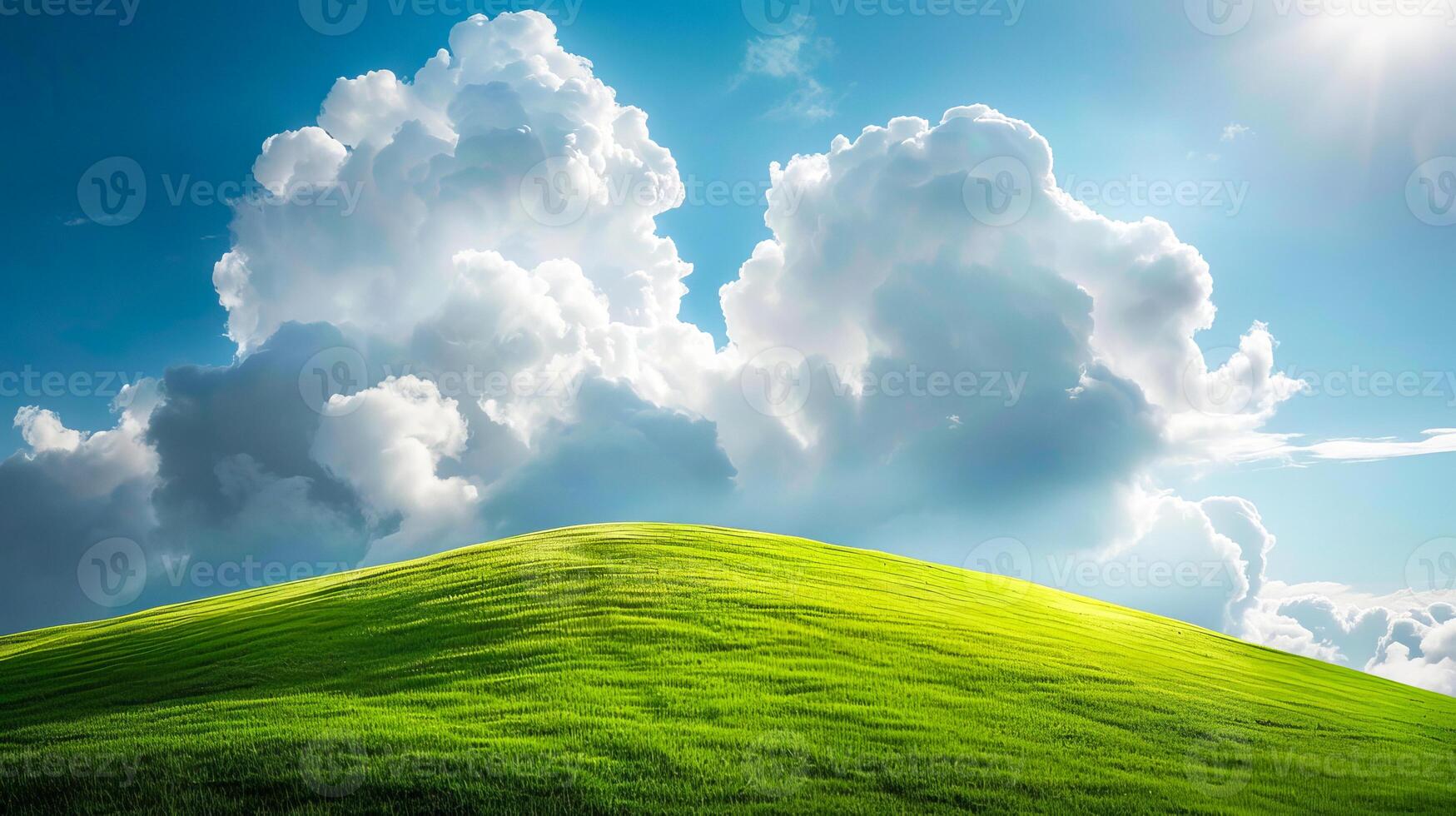 Landscape with clouds resting on a green hillside in sunlight. photo