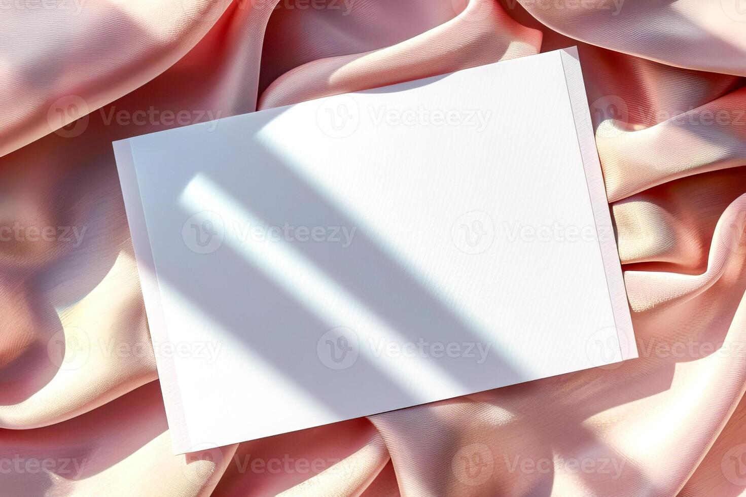 Minimalist aesthetic mockup from white blank A5 letterhead on pink silk fabric. photo