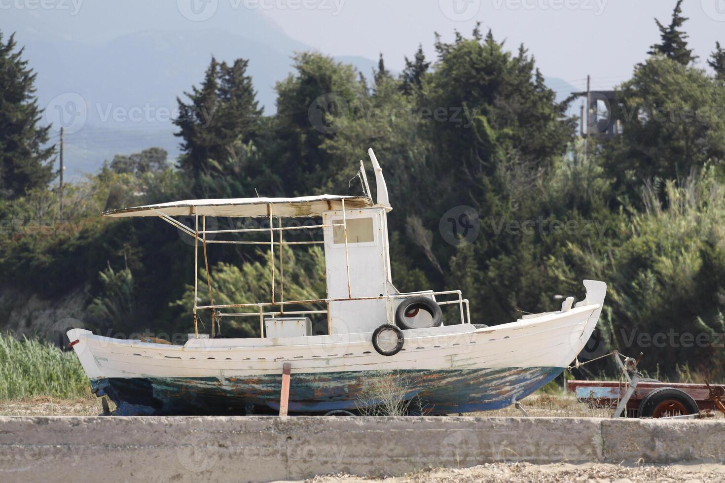 fishing boat on the shore photo
