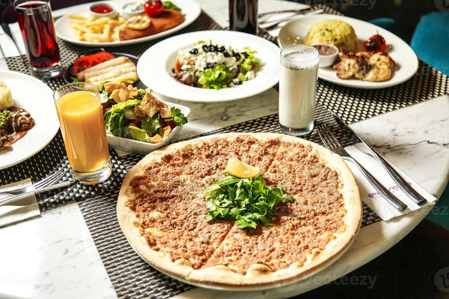 Table Adorned With Plates of Food and Drinks photo