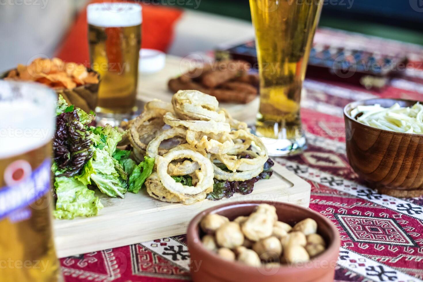 Table Displaying Delicious Food and Glasses of Beer photo