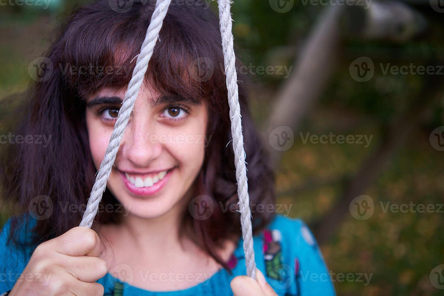 girl in a dress with balloons on a swing in an autumn garden photo