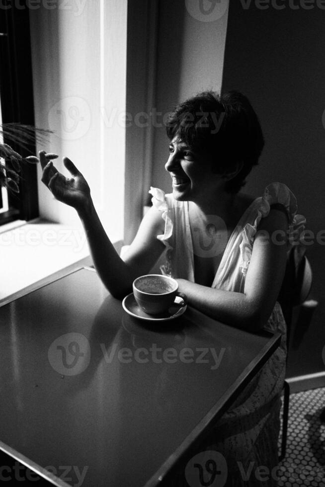 a girl with a short haircut in a restaurant, black and white photo in vintage style
