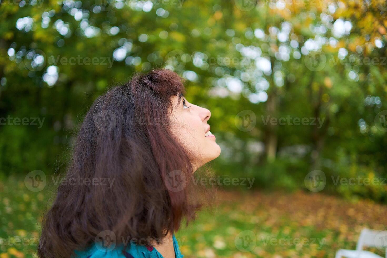 a girl in a dress with balloons is playing in the autumn garden photo
