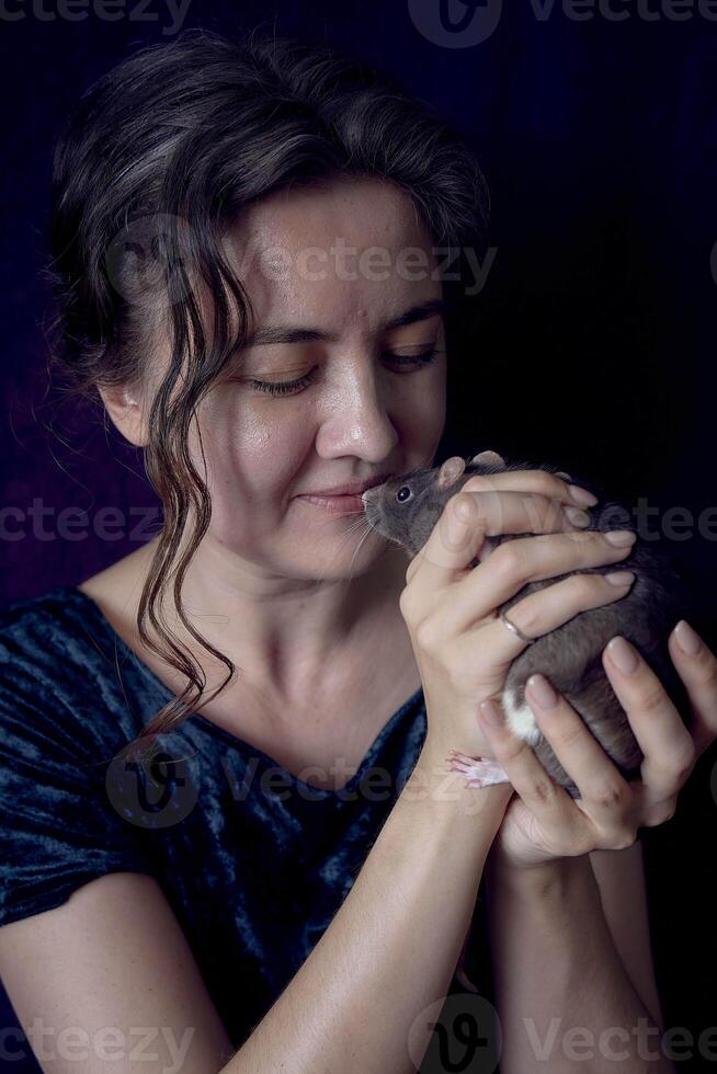 a berkshire standard rat cuddles with its owner photo
