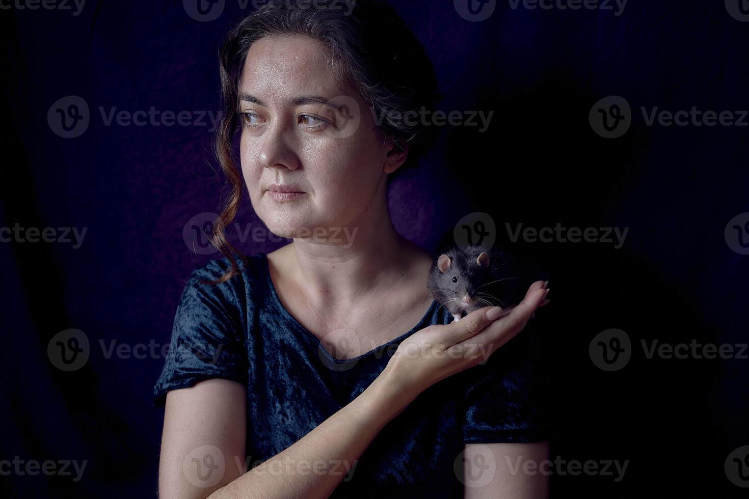 a berkshire standard rat cuddles with its owner photo