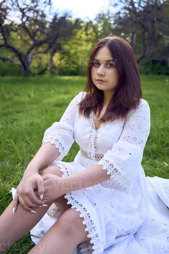 a portrait of a teenage girl in a pastel dress on a picnic photo