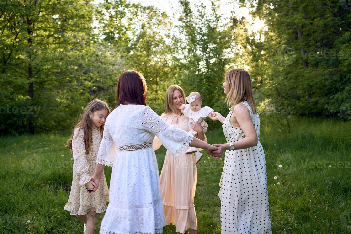 five women of different ages are circling in a dance photo