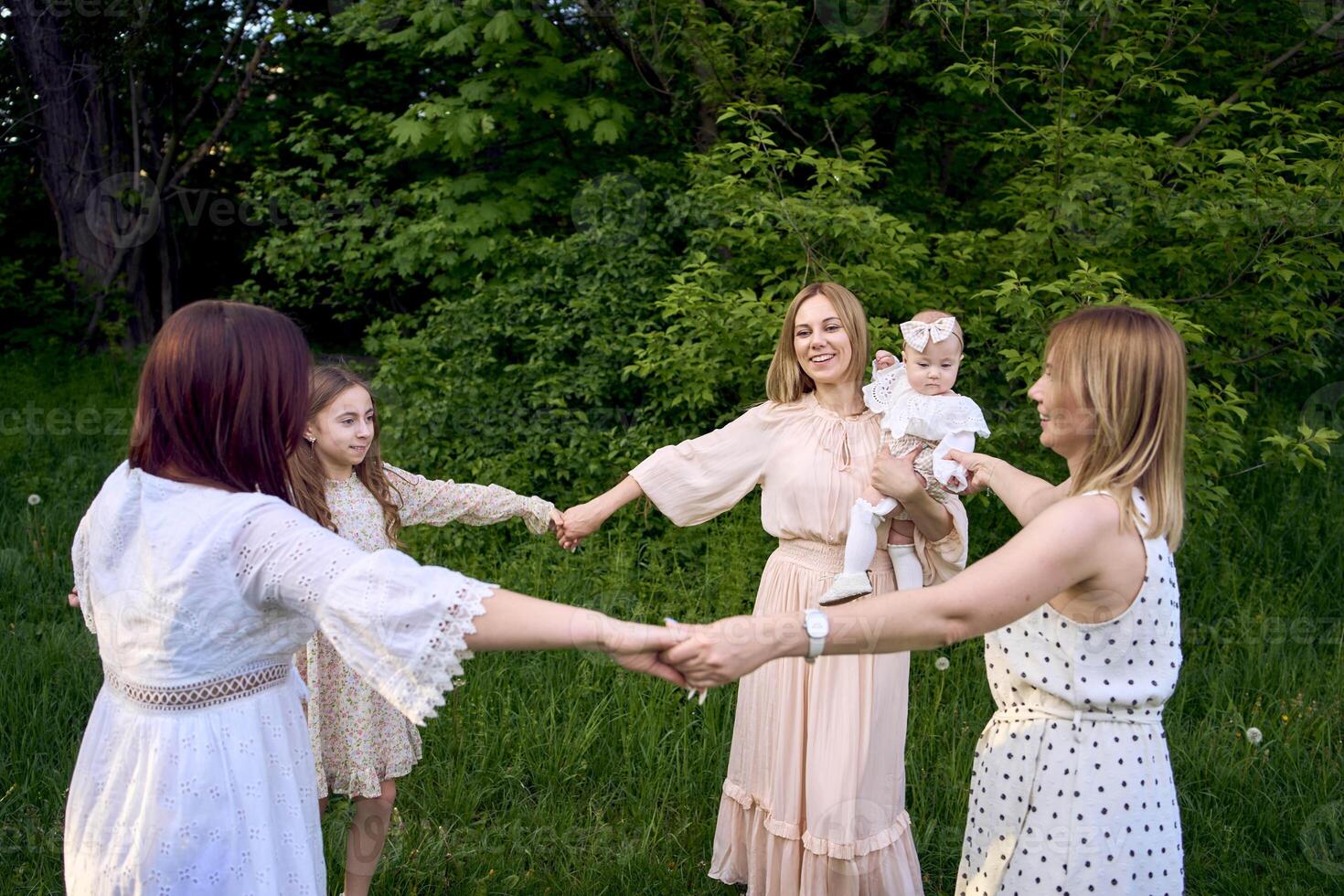 five women of different ages are circling in a dance photo
