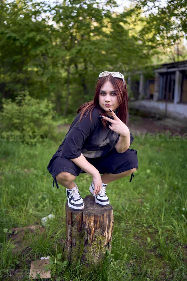 a teenage girl in black clothes in grunge style photo
