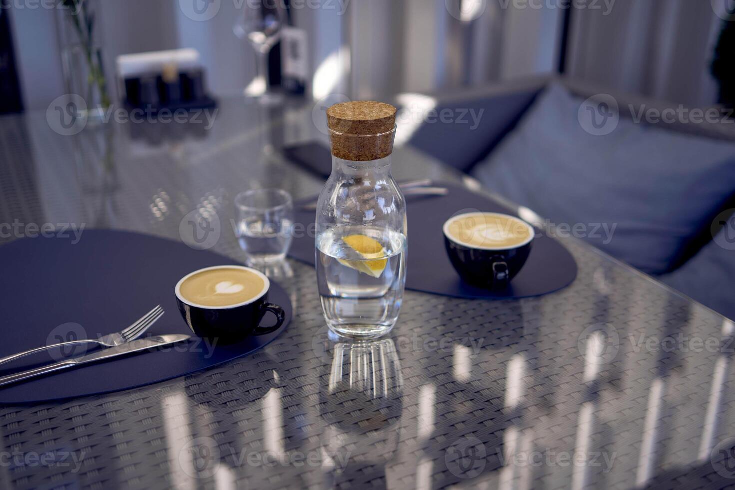two cups of coffee, latte and cappuccino on a table in a cafe photo