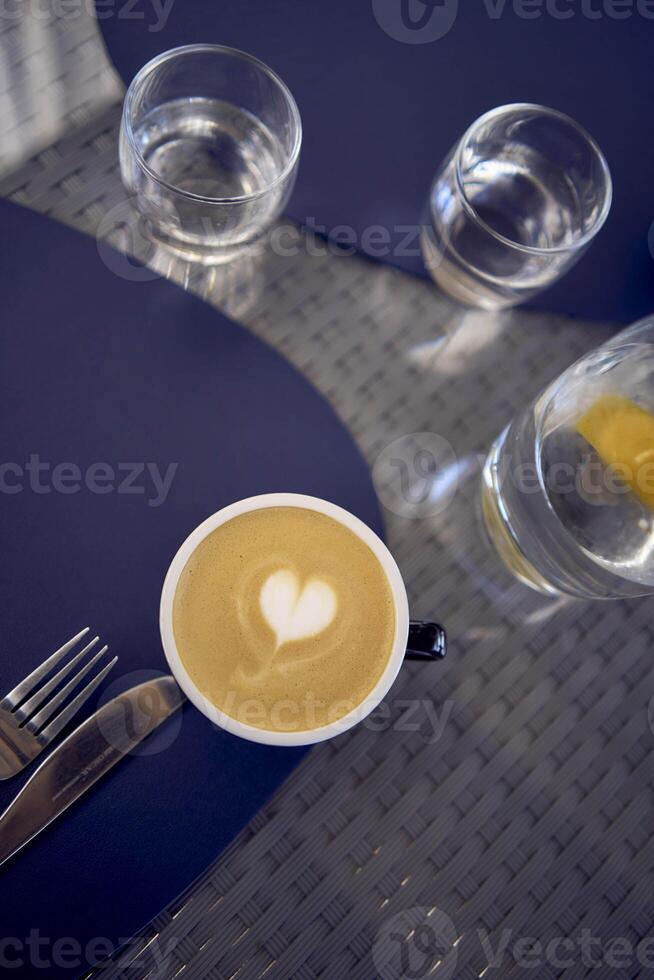 cups of coffee, latte and cappuccino on a table in a cafe photo