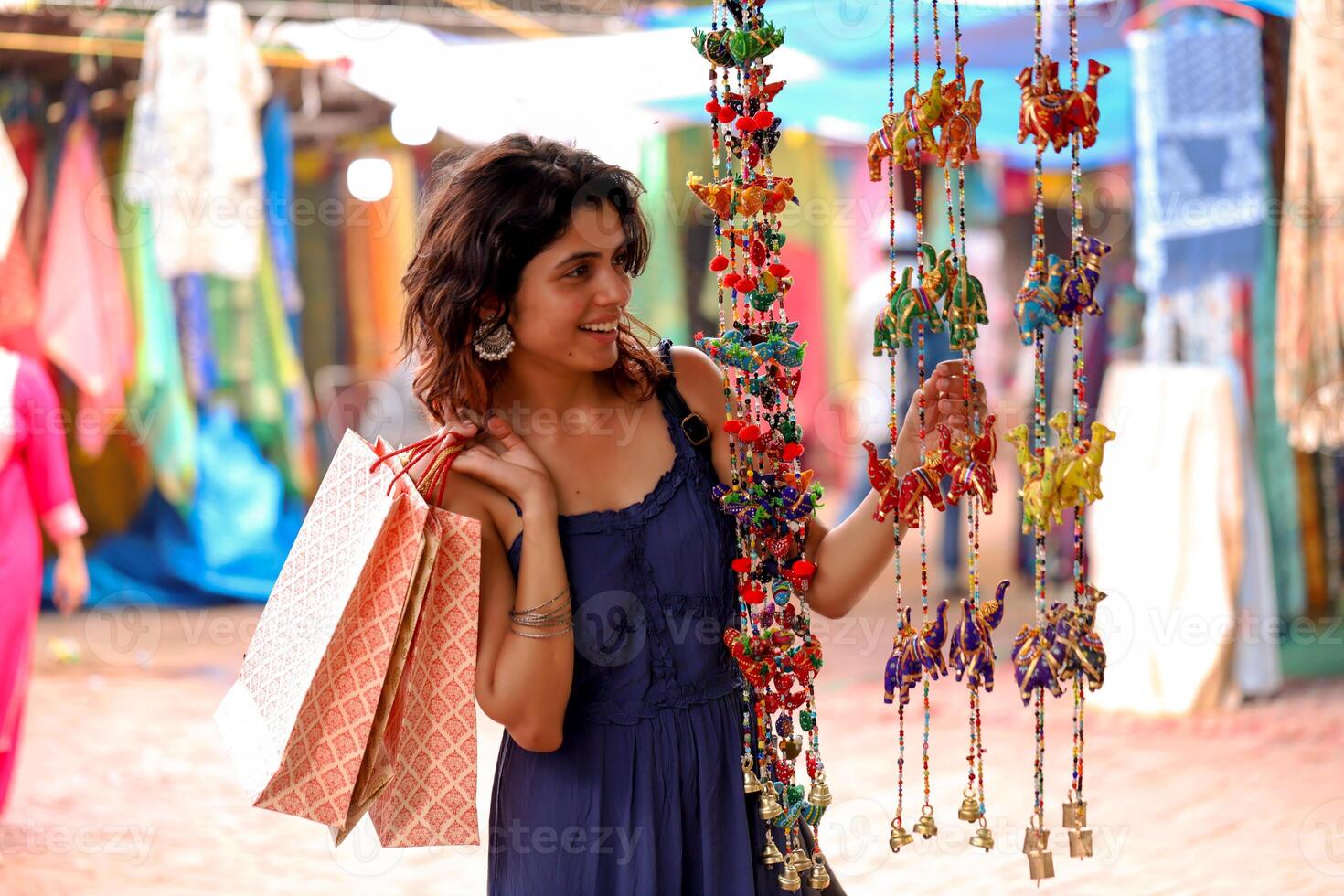 Pretty Model In Blue Cotton One Piece Dres Looking At Multicolour Rajasthani Hanging Decoration photo