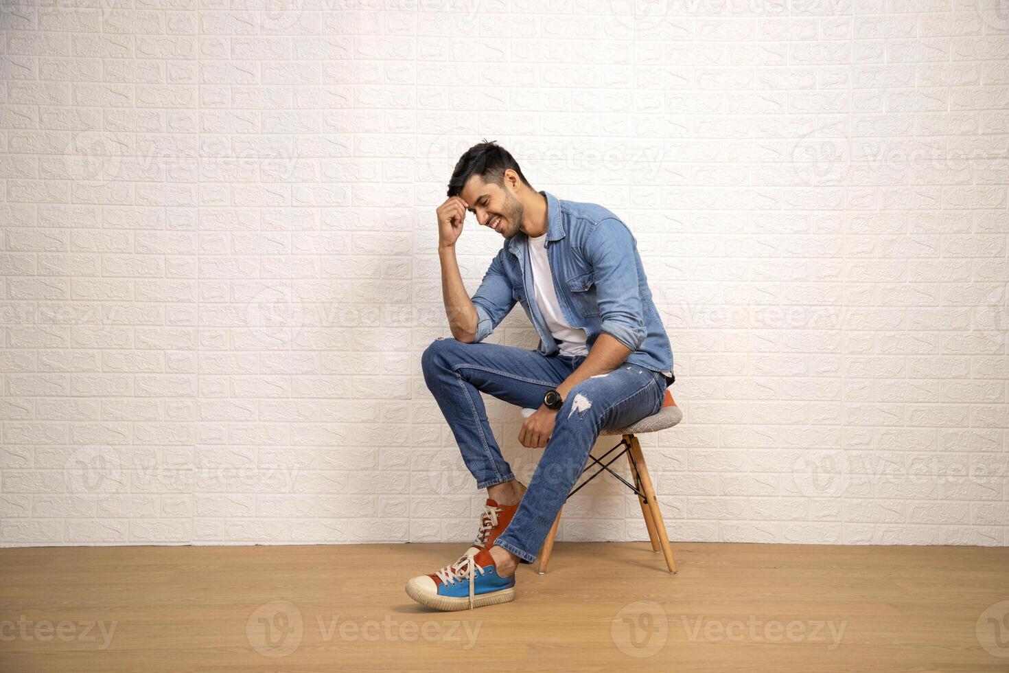Shy Guy Is Blushing While Sitting On Chair photo
