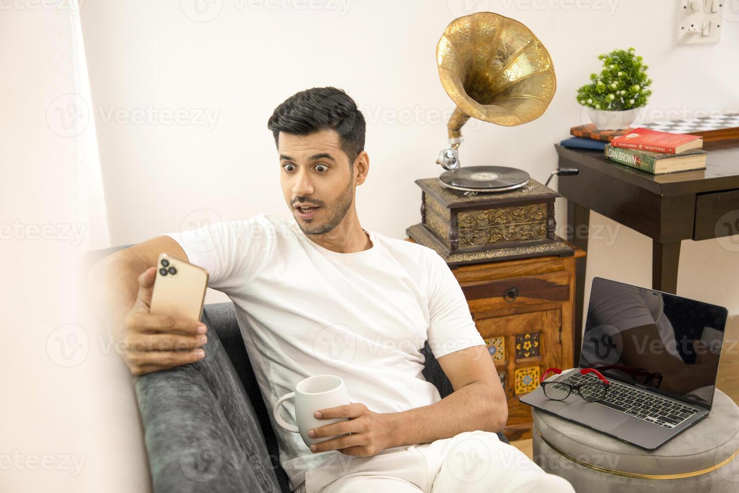Shocked Man Horrified Looking At Cellphone photo