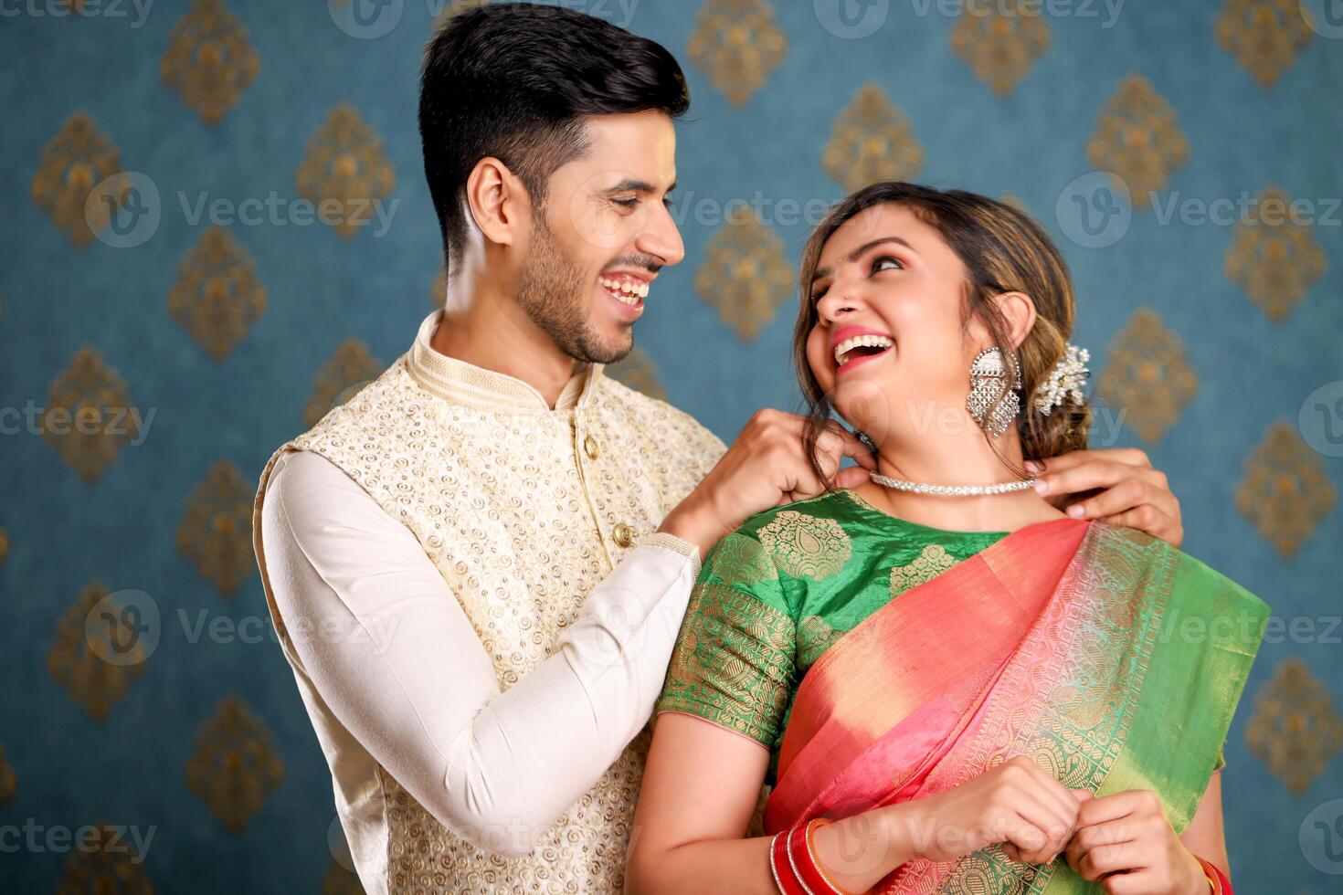 Image Of Beautiful Couple In Traditional Indian Attire Giving His Wife Necklace photo