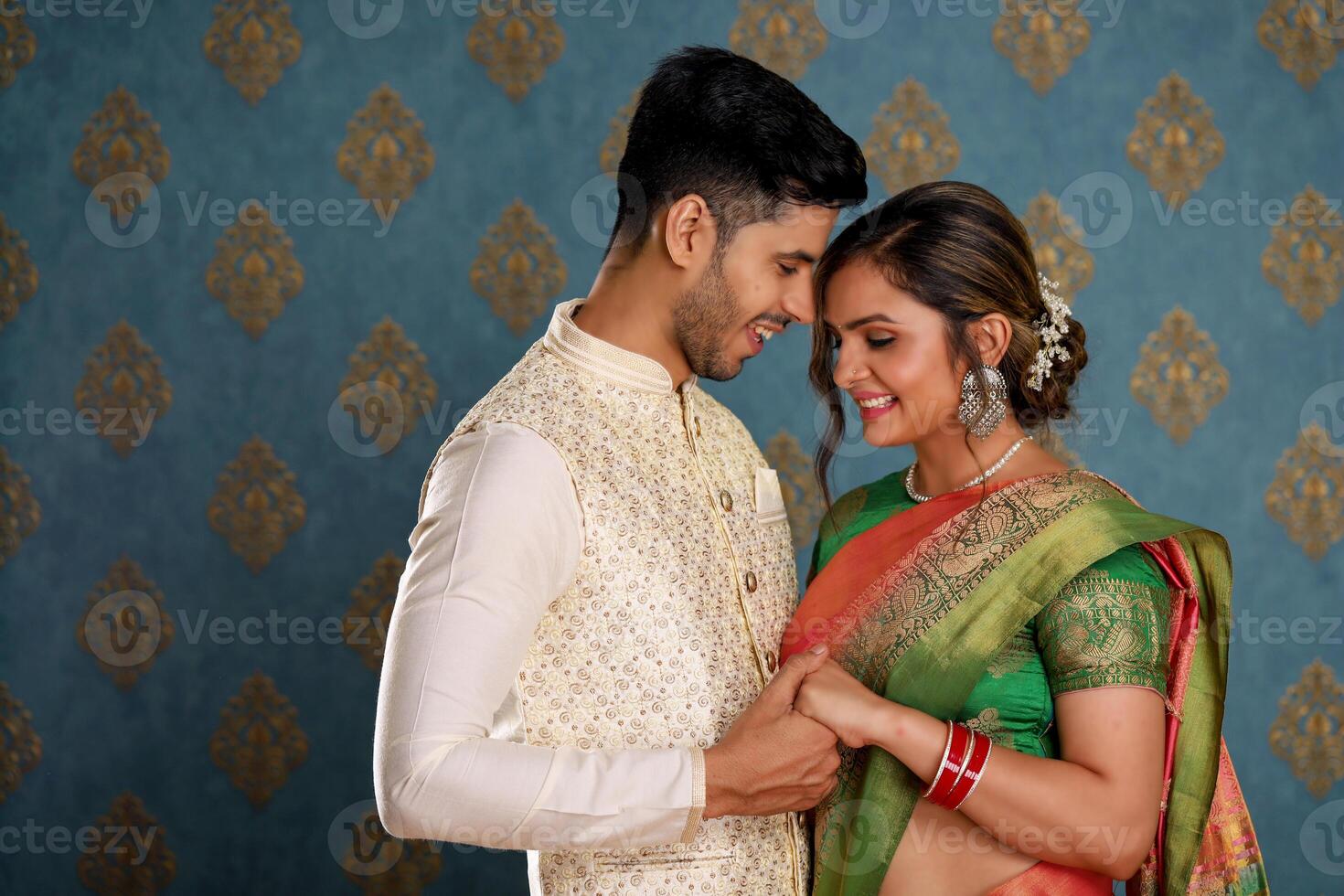 A Romantic Indian Couple In Traditional Attire Posing In Front Of The Camera photo