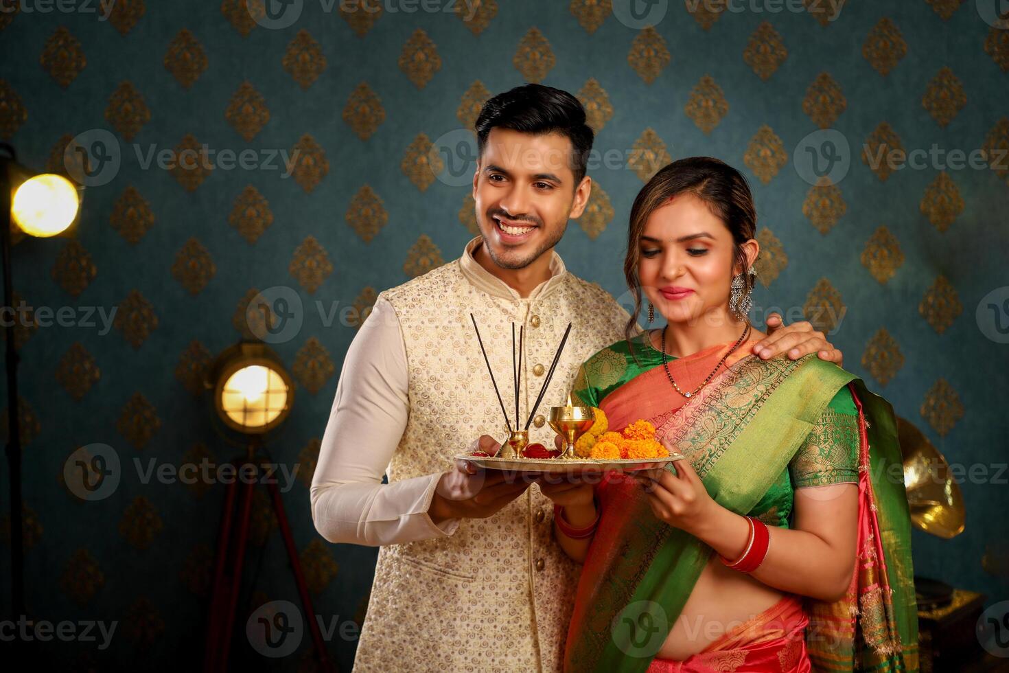 Picture Of Indian Couple In Traditional Attire For The Diwali Festival Carrying Pooja Plate In Their Hands photo