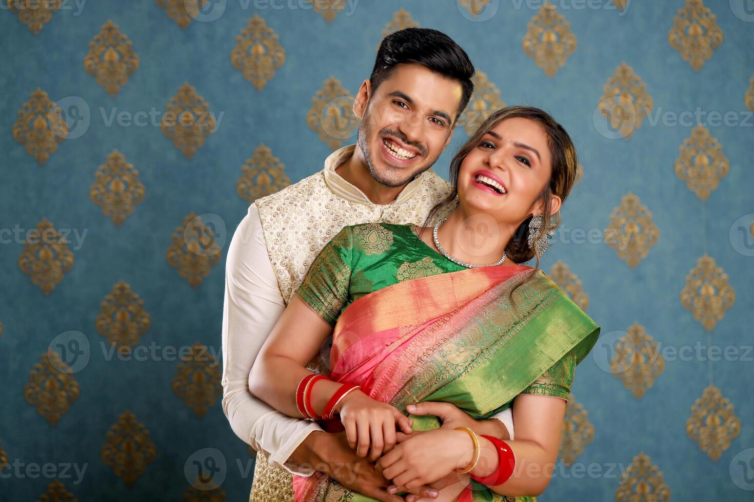 Image Of A Couple Smiling In Front Of The Camera Wearing Traditional Outfits photo