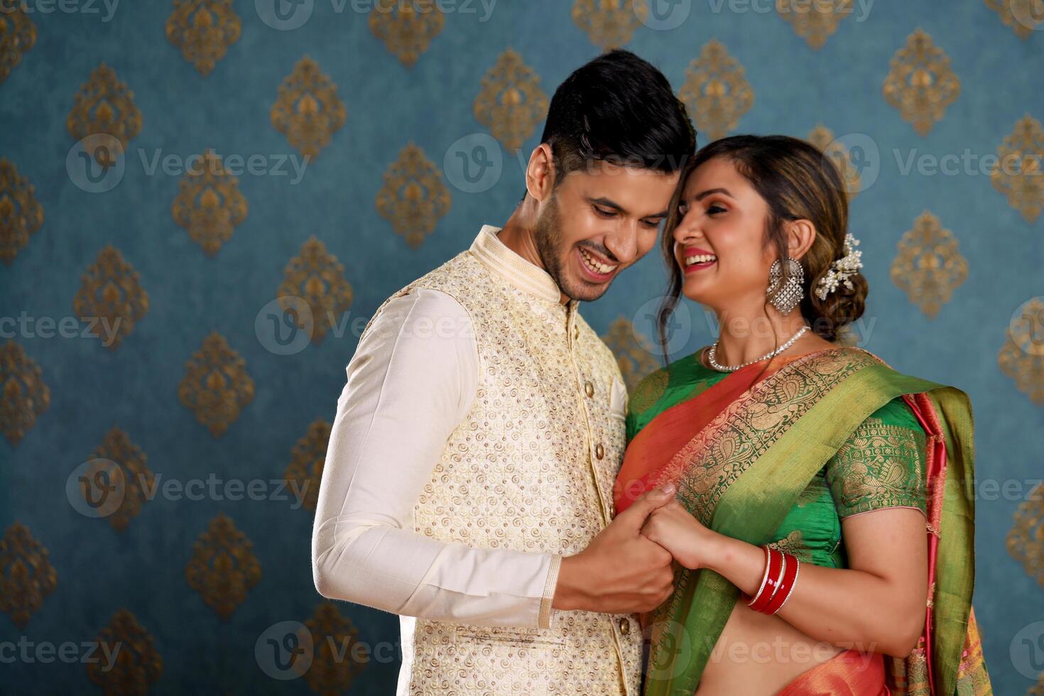 Happy Married Couple In Indian Outfit Holding Hands photo