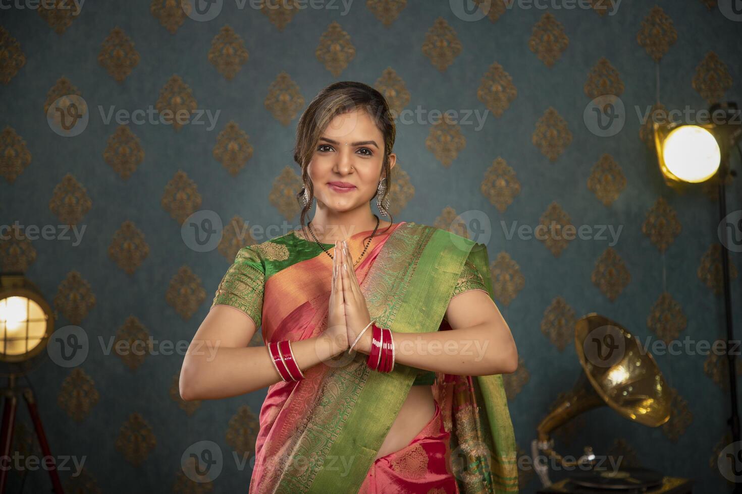 A Sweet Lady In Traditional Attire During Diwali Festival Showing Namaste Gesture In Front Of The Camera photo