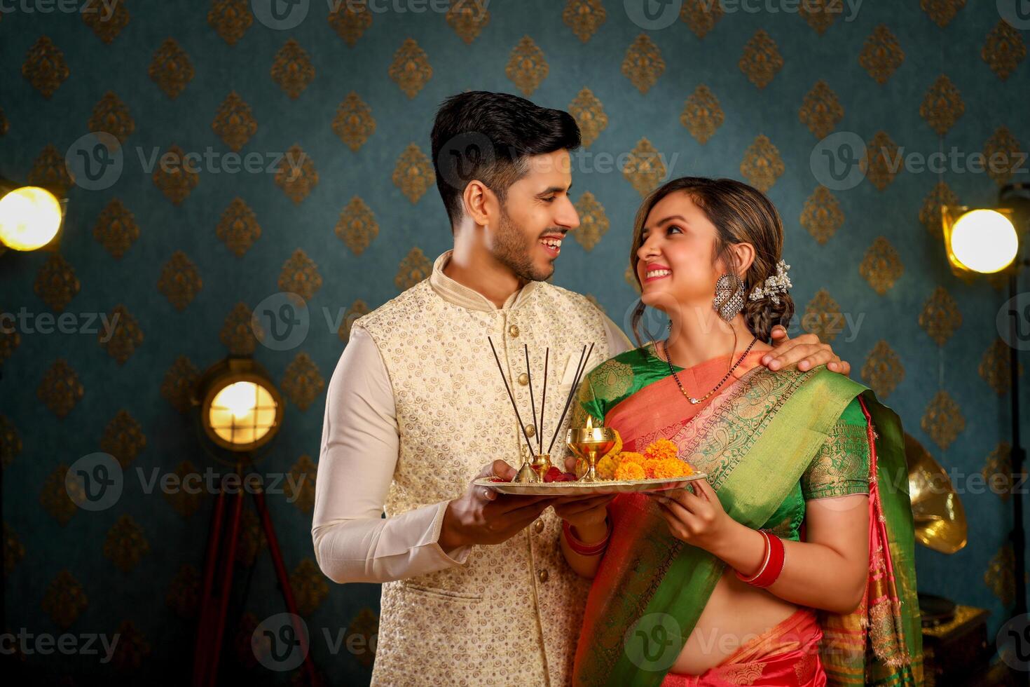 Romantic Couple In Indian Traditional Outfit Holding Puja Plate In Hand photo