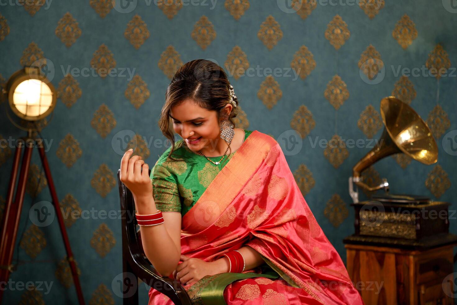 Indian Model Pic Posing While Seated On A Chair During The Diwali Festival photo