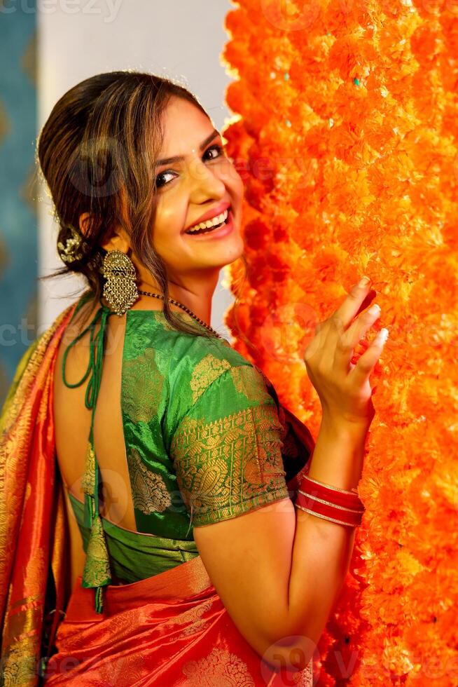 Picture Of An Adorable Couple Wearing Traditional Indian Attire Holding A Plate Of Ladoos In Their Hands And Smile photo