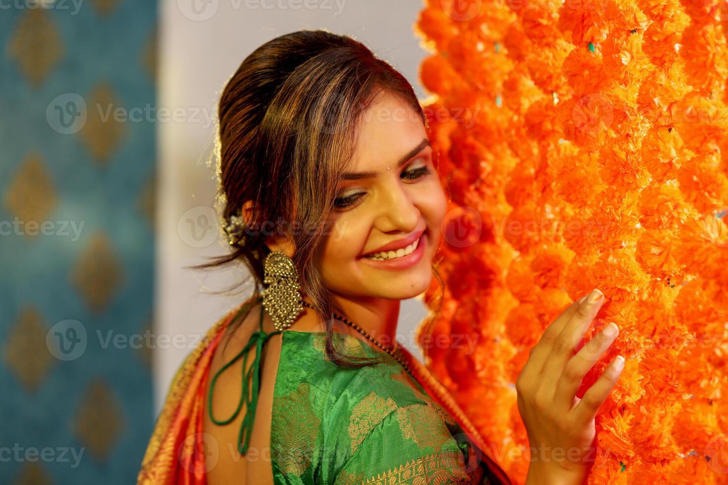 Gorgeous Young Lady Standing Next To The Flower-Decorated Wall photo