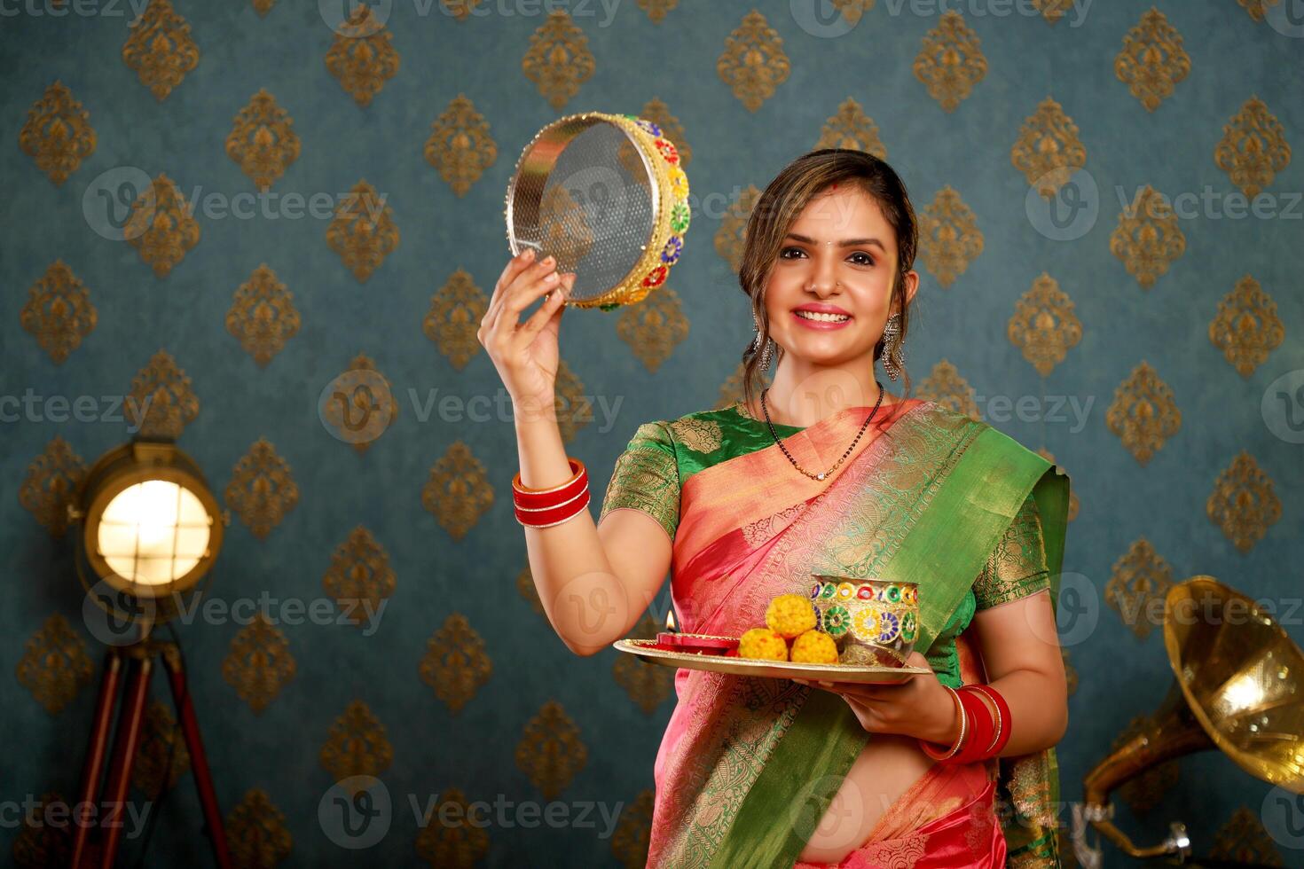 An Indian Housewife In Saree Holding Sieve And Pooja Thali At Karwa Chauth photo