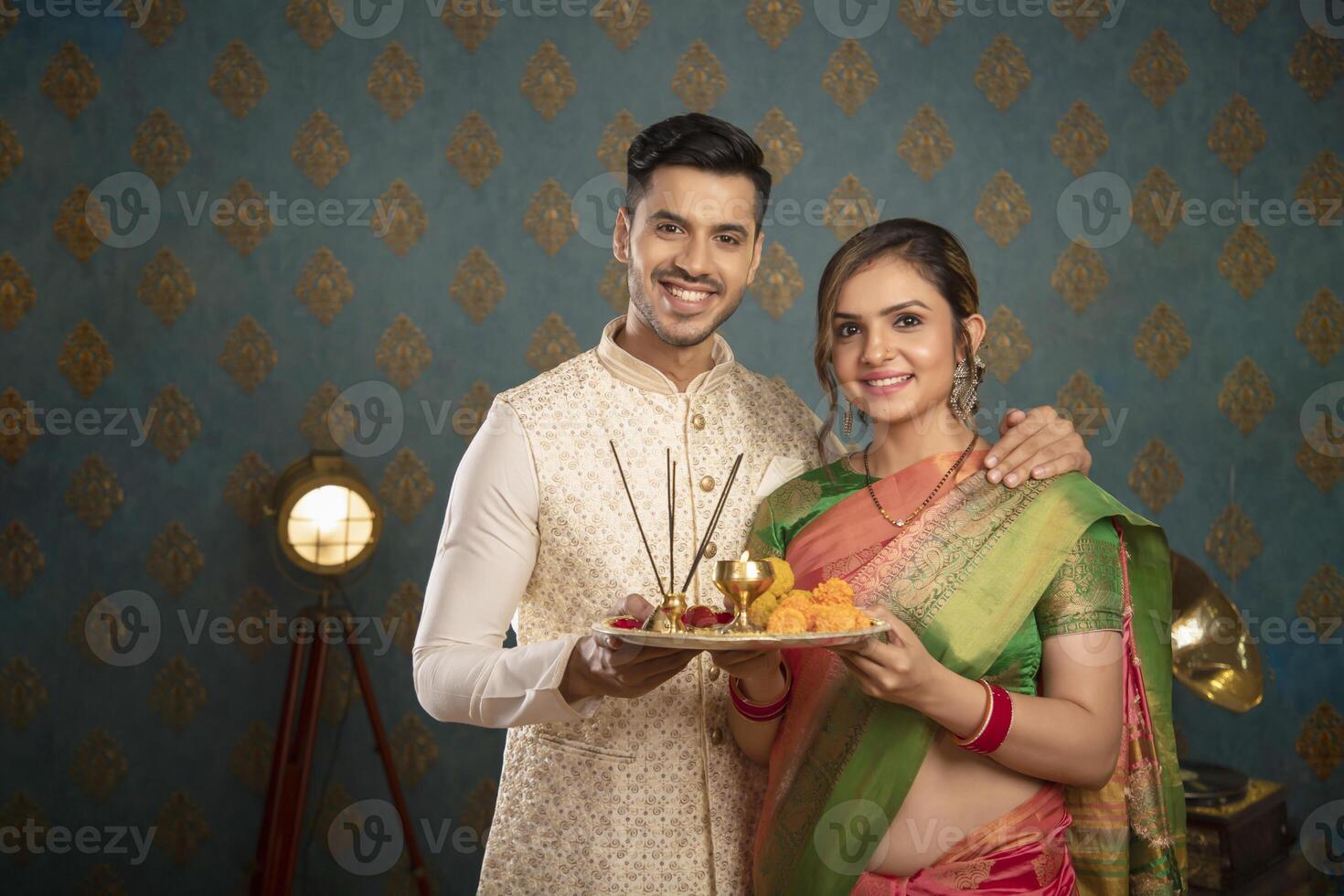 A Young Couple Enjoying Themselves While Holding Shopping Bags And Sitting On A Chair In Front Of The Camera photo