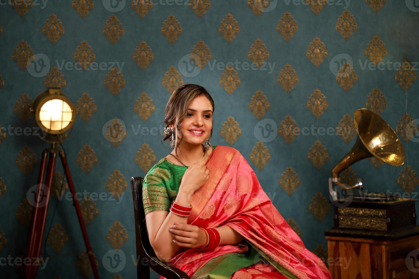 Smiling Beautiful Couple In Traditional Indian Attire Holding Plate Of Ladoo photo
