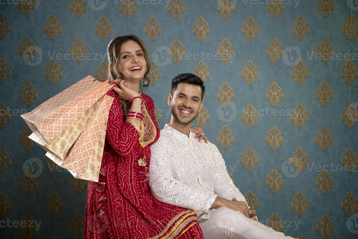 An Image Of A Romantic, Lovely Couple In Front Of The Camera Holding Shopping Bags photo