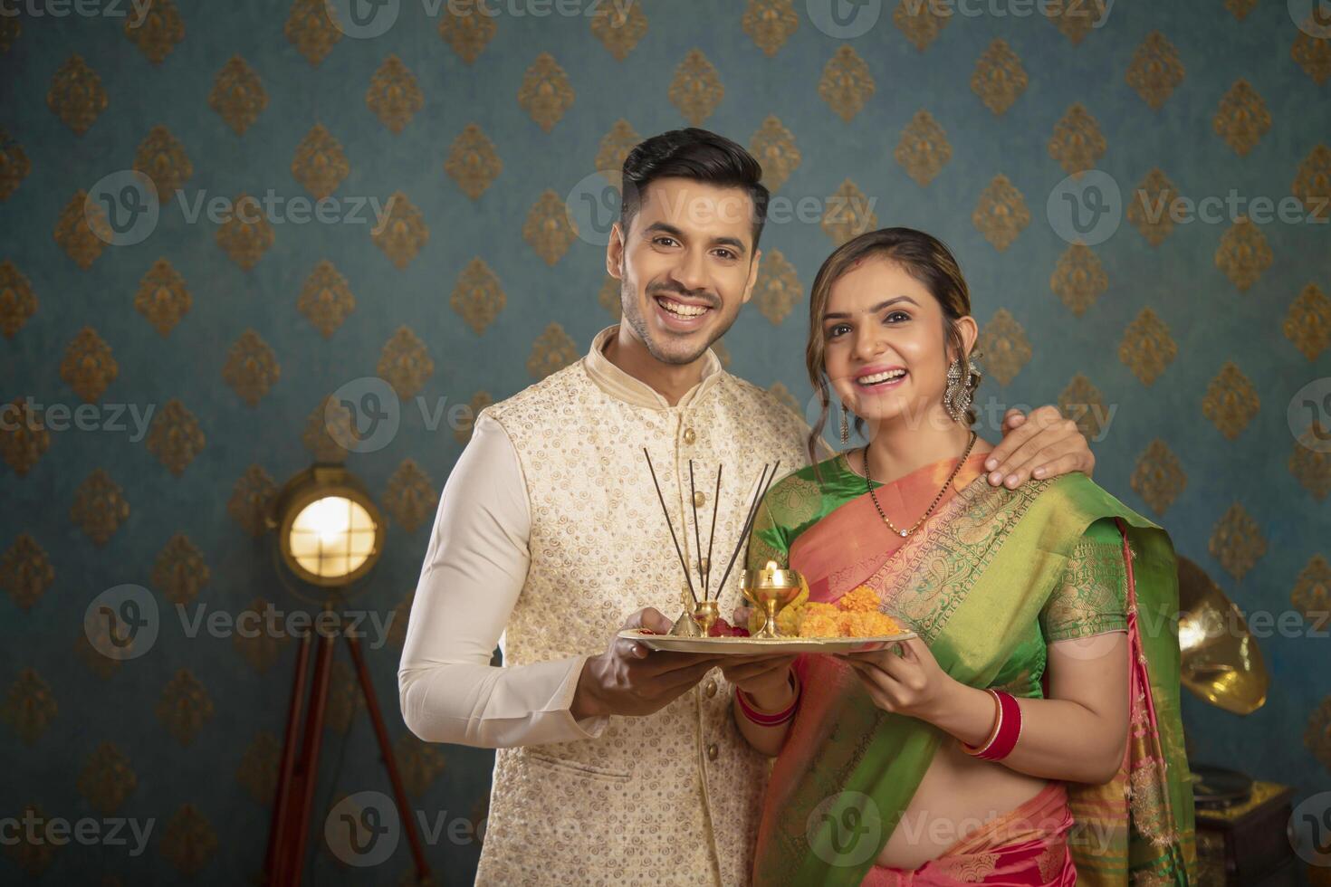 A Young Couple Enjoying Themselves While Holding Shopping Bags And Sitting On A Chair In Front Of The Camera photo