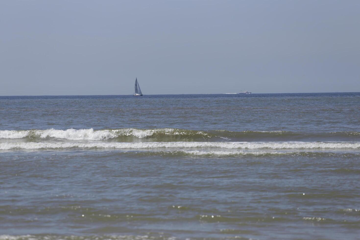 sailboat on the north sea, seen from the shore photo